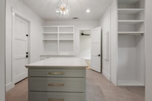 Spacious Walk-In Closet with Built-In Shoe Storage and Island