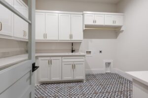 Laundry Room with White Cabinetry & Bold Patterned Floors